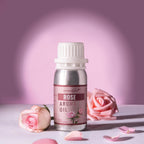 Rose aroma oil bottle with pink roses and petals