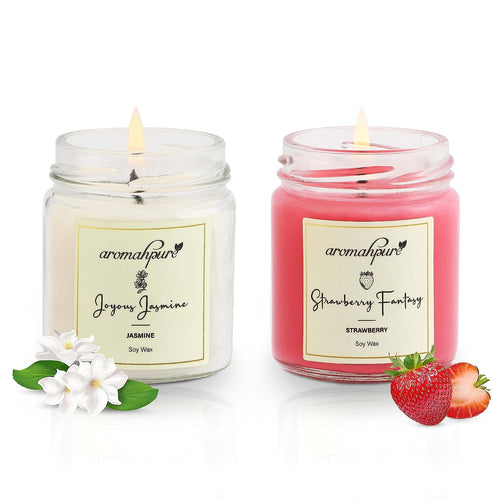 Two scented soy wax candles in round jars, one labeled 'Joyous Jasmine' and the other 'Strawberry Fantasy'. Both have white wax and are adorned with flower and fruit decorations.
