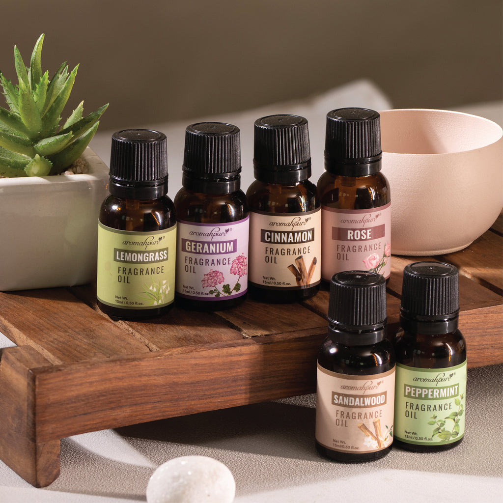 Set of six fragrance oils on wooden tray